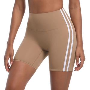 Detail of high waist yoga shorts with white side stripes and stretch compression fabric
