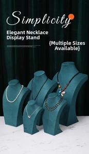 Deep green velvet necklace display bust set on marble surface for jewelry store decor