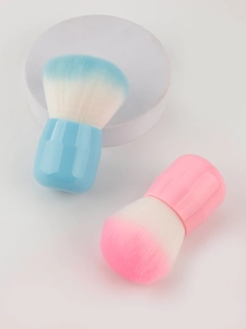 Detail of mushroom head makeup brushes with dense synthetic bristles in blue and pink colors