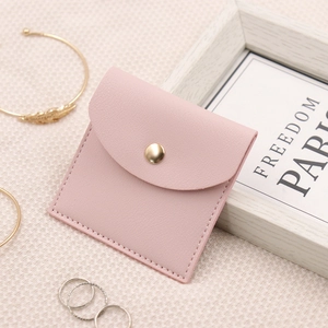 Detailed close-up of a pink microfiber jewelry pouch with a premium gold snap button