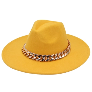 Close-up of bright yellow fedora hat featuring a chunky rose gold acrylic chain decoration