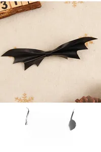 Flat lay of gothic black leather bat wing hair clip with festive winter decorations