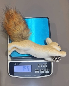 Lightweight plush squirrel decoration holding a pinecone, weighing only 19.5g