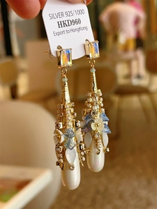 Detail of bohemian S925 silver fringe drop earrings with crystals and pearl charms
