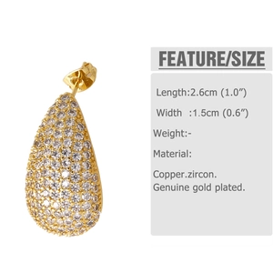 Macro shot of gold-plated teardrop earrings showing precise dimensions and cubic zirconia