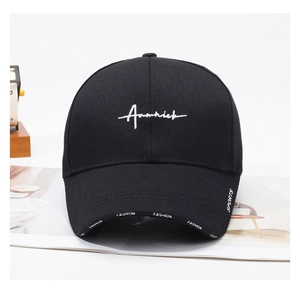 Close-up of black cotton baseball cap with Aamnick embroidery and side fashion tape detail