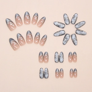 Detail of blue cat-eye press on nails with silver floral and leaf patterns on pink base