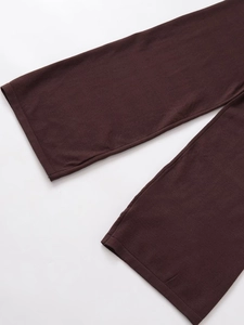 Detailed close-up of the dark brown knitted trousers leg openings and stitching quality