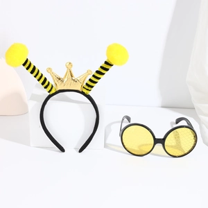 Close-up of yellow bee party set with crown headband and honeycomb pattern glasses