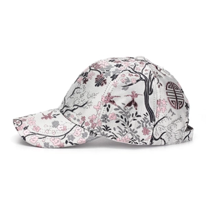 Close-up of pink cherry blossom embroidery and garden patterns on gray baseball cap