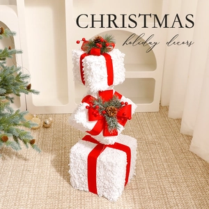 Three beige plush Christmas gift box set with red ribbons and pine cone decorations