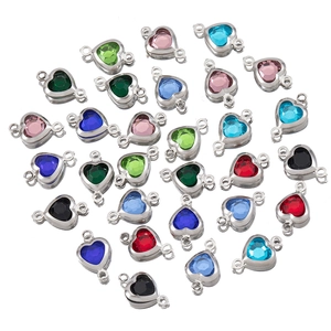 Close-up of heart-shaped crystal charms with silver frames in multiple colors for DIY jewelry