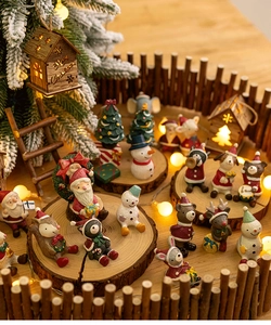 Close-up of resin Christmas miniatures like Santa and snowman on a rustic wooden base