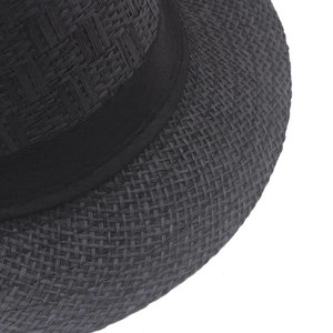 Close-up of the woven texture and black ribbon detail on the summer straw fedora hat