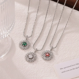 Sparkling sunflower pendant necklace in silver with red, green, and white gemstones