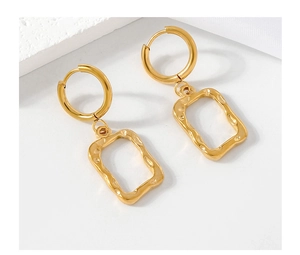 Macro shot of gold geometric earrings featuring hammered texture and hollow rectangle charm