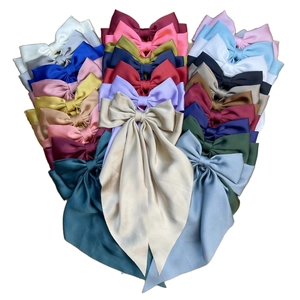 Close-up of assorted satin bow hair clips with long streamers in various vibrant colors