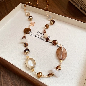 Ethnic ceramic butterfly necklace with amber beads and hand-woven cord in earth tones
