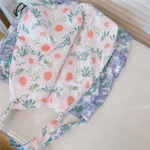 Detailed macro of floral cotton tote bag fabric with pink peony and blue hydrangea prints