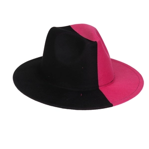 Detail of a two-tone black and magenta wide-brim wool fedora hat with a gradient finish