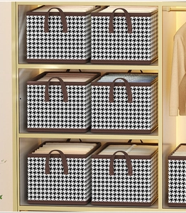 Wardrobe storage box with houndstooth pattern and handles for organized clothing storage