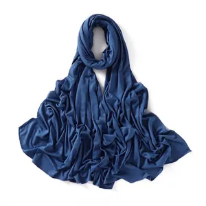 Close-up of navy blue jersey scarf showing soft modal texture and stitched edge