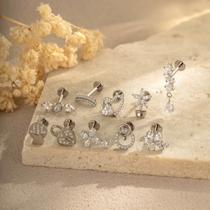 Set of G23 titanium flat back studs with flower and star shaped clear crystals