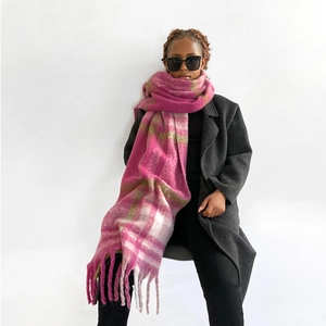 Detail showing the long tassels and soft mohair texture of the pink plaid scarf
