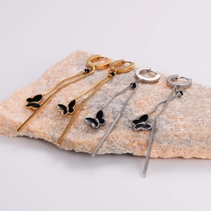 Detailed shot of long butterfly tassel earrings in gold and silver finish steel