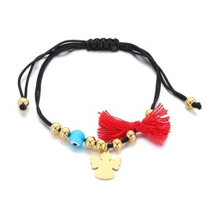 Handmade woven Evil Eye bracelet with gold angel charm and red tassel on white background