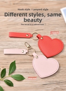 Detail of red and pink heart-shaped leather vanity mirrors with metal lobster clasps
