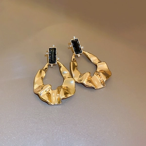 Golden irregular crinkle hoop earrings with black rectangular crystals and small diamonds