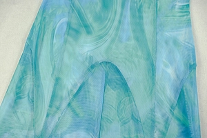 Detail of artistic marble print on semi-transparent mesh fabric with fine stitching