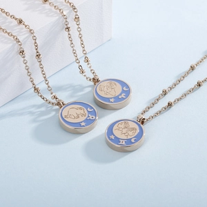 Golden zodiac pendant necklaces with Aries, Taurus, and Gemini motifs on blue background