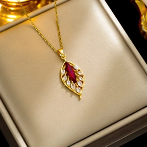 Elegant gold leaf pendant necklace with red marquise zircon and sparkling accents