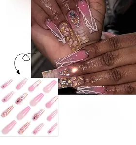 Detailed view of pink gradient ballet nails with 3D crystal butterflies and gold foil flakes