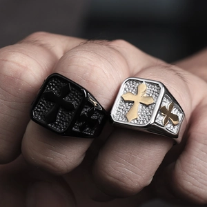 Macro shot of vintage cross rings with hammer texture and matte black finish on fingers