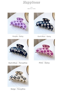 Detail of five hollow acetate hair claws with daisy and winter sweet floral patterns