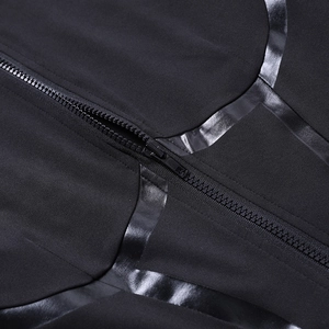 Detail of front zipper closure and glossy faux leather tape on black athletic jumpsuit