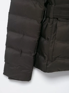 Detail view of the quilted waterproof fabric with a waist belt and windproof cuffs