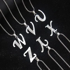 Silver stainless steel letter necklaces U-Z with sparkling crystals on black background