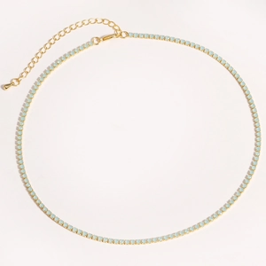 Detail view of a gold tennis necklace with light blue round stones and lobster clasp