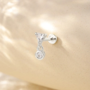 Macro shot of S925 sterling silver earring with triangle and round clear gemstones