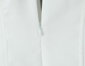 Close-up of the high-quality invisible zipper on a white French vintage dress