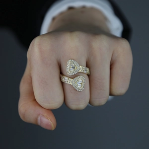 Gold heart-shaped ring with pavé cubic zirconia worn by a model in a gray suit