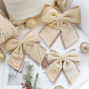 Three champagne velvet Christmas bows with gold glitter edges for festive tree decoration