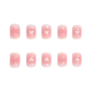 Pink gradient press-on nails with white heart motifs and French tips, short round style