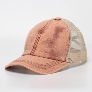 Detailed view of orange washed cotton fabric and breathable mesh on ponytail baseball cap