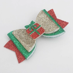 Glittery Christmas hair bow clip with reindeer antlers and festive gift box decor