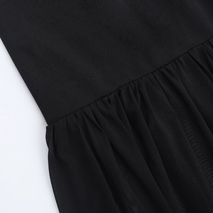 Close-up of pleated mesh splicing and smooth fabric details on the black off-shoulder dress